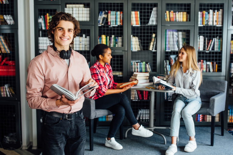 three-young-teenagers-talking-about-project-doing-work-together-meeting-library-room